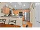 Bright kitchen with stainless steel appliances, light wood cabinets and breakfast bar at 126 Cottage Club Dr, Locust Grove, GA 30248