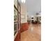 Open living room with gleaming hardwood floors, fireplace, and plenty of natural light at 126 Cottage Club Dr, Locust Grove, GA 30248