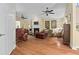 Spacious living room featuring hardwood floors, a cozy fireplace, and comfortable seating at 126 Cottage Club Dr, Locust Grove, GA 30248