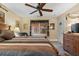 Relaxing main bedroom featuring a plush queen-sized bed, ceiling fan, dresser, and natural light at 126 Cottage Club Dr, Locust Grove, GA 30248
