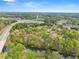 Expansive aerial view showcasing a lush landscape with a river running through a wooded neighborhood at 1870 Chattahoochee Run Dr, Suwanee, GA 30024