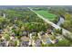 Stunning aerial view of a serene neighborhood with lush green trees, a river, and well-maintained homes at 1870 Chattahoochee Run Dr, Suwanee, GA 30024