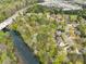 Beautiful aerial view showcasing neighborhood homes nestled amidst trees, near a river, and a highway at 1870 Chattahoochee Run Dr, Suwanee, GA 30024