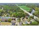 Picturesque aerial view of homes near the river, adjacent to grassy fields and a roadway at 1870 Chattahoochee Run Dr, Suwanee, GA 30024