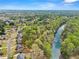 Breathtaking aerial view showcasing a river near a neighborhood with tree-lined streets and blue skies at 1870 Chattahoochee Run Dr, Suwanee, GA 30024