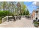 Inviting outdoor deck featuring elegant patio furniture and decorative string lights for relaxation and enjoyment at 1870 Chattahoochee Run Dr, Suwanee, GA 30024
