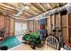 Unfinished basement featuring exposed framing, wood ceiling, and a John Deere riding lawn mower at 1870 Chattahoochee Run Dr, Suwanee, GA 30024