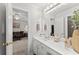 Ensuite bathroom featuring a white vanity with a view into an adjacent living space at 1870 Chattahoochee Run Dr, Suwanee, GA 30024
