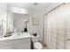 Bright bathroom with white cabinets and a walk-in shower with a light-striped curtain at 1870 Chattahoochee Run Dr, Suwanee, GA 30024