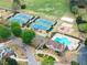 Aerial shot showcases the community pool and recreation area including tennis courts and playground at 1870 Chattahoochee Run Dr, Suwanee, GA 30024