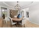Formal dining room with decorative mirror, elegant light fixture, and natural light at 1870 Chattahoochee Run Dr, Suwanee, GA 30024