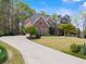 Spacious home with a long driveway and meticulously maintained lawn, creating an inviting and elegant appearance at 1870 Chattahoochee Run Dr, Suwanee, GA 30024