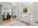 Bright foyer with hardwood floors, featuring a home office space and a view of the front yard at 1870 Chattahoochee Run Dr, Suwanee, GA 30024