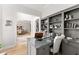 Stylish home office with built-in shelving, providing an organized and functional workspace with a view into the dining room at 1870 Chattahoochee Run Dr, Suwanee, GA 30024