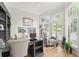 Bright home office with hardwood floors, built in shelving and a large bay window at 1870 Chattahoochee Run Dr, Suwanee, GA 30024