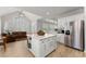 Bright kitchen with large island, stainless steel refrigerator, and ample counter space at 1870 Chattahoochee Run Dr, Suwanee, GA 30024
