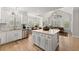 Open-concept kitchen with an island, stainless steel appliances, and hardwood floors at 1870 Chattahoochee Run Dr, Suwanee, GA 30024