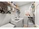 Functional laundry room with washer, dryer, and shelving for organized storage at 1870 Chattahoochee Run Dr, Suwanee, GA 30024
