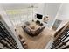 Aerial view of large living room with fireplace, high ceilings, and floor-to-ceiling windows at 1870 Chattahoochee Run Dr, Suwanee, GA 30024