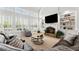 Spacious living room with large windows, a cozy fireplace, and built in shelving at 1870 Chattahoochee Run Dr, Suwanee, GA 30024