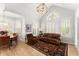 Cozy living room with natural light, plantation shutters, and hardwood floors at 1870 Chattahoochee Run Dr, Suwanee, GA 30024