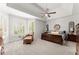 Spacious main bedroom featuring natural light and tray ceiling with ceiling fan at 1870 Chattahoochee Run Dr, Suwanee, GA 30024