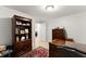 Well-lit office with built-in shelving, dark wood furniture, and a view of the interior at 1870 Chattahoochee Run Dr, Suwanee, GA 30024