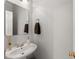 Cozy powder room featuring a vessel sink, elegant faucet, mirror, and towel rack at 1870 Chattahoochee Run Dr, Suwanee, GA 30024