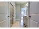 Hallway view to the bathroom featuring the glass shower and vanity at 3871 Shelleydale Dr, Powder Springs, GA 30127
