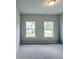 Bright bedroom with plush carpeting and abundant natural light from two windows at 3871 Shelleydale Dr, Powder Springs, GA 30127