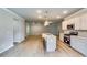 Spacious kitchen with stainless steel appliances, quartz counters, and an open living area at 3871 Shelleydale Dr, Powder Springs, GA 30127