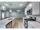 Modern kitchen open to the living area, featuring stainless steel appliances and sleek finishes at 3871 Shelleydale Dr, Powder Springs, GA 30127
