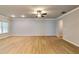 Spacious living room with wood floors, ceiling fan, and plenty of natural light at 3871 Shelleydale Dr, Powder Springs, GA 30127