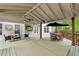Relaxing covered back porch with ceiling fan, outdoor furniture, hot tub and dining area at 310 Kingspring Ct, Roswell, GA 30076