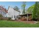 Spacious backyard with well-maintained lawn, mature trees, and a charming covered deck at 310 Kingspring Ct, Roswell, GA 30076