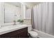 Cozy bathroom featuring a modern vanity, updated fixtures, and a shower-tub combination with privacy curtain at 310 Kingspring Ct, Roswell, GA 30076
