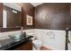 Stylish half bathroom featuring modern fixtures, vessel sink, and decorative accents, perfect for guests at 310 Kingspring Ct, Roswell, GA 30076