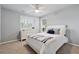 Bright bedroom with a ceiling fan, neutral walls, and a well-placed window for optimal natural light at 310 Kingspring Ct, Roswell, GA 30076