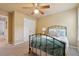 Comfortable bedroom with natural light, ceiling fan, and a neutral color palette, offering a relaxing atmosphere at 310 Kingspring Ct, Roswell, GA 30076