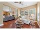 Cozy living room with hardwood floors, lots of natural light, high ceilings, open to the kitchen and dining area at 310 Kingspring Ct, Roswell, GA 30076