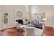 Inviting living room featuring a fireplace, hardwood floors, tall ceilings, and lots of natural light at 310 Kingspring Ct, Roswell, GA 30076