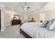 Spacious main bedroom featuring a tray ceiling, ceiling fan, carpet, and ample natural light at 310 Kingspring Ct, Roswell, GA 30076
