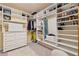 Spacious walk-in closet with custom shelving, drawers, and ample storage space for clothing and accessories at 310 Kingspring Ct, Roswell, GA 30076