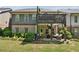 Two-story home featuring a covered patio and upper deck accessible from the backyard at 95 Nesbit Reserve Ct, Alpharetta, GA 30022