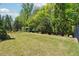 Spacious backyard with lush greenery, fenced perimeter, and mature trees for privacy at 95 Nesbit Reserve Ct, Alpharetta, GA 30022