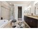 Elegant bathroom featuring a soaking tub, glass-enclosed shower, double vanity, and contemporary fixtures and finishes at 95 Nesbit Reserve Ct, Alpharetta, GA 30022