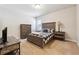 Comfortable bedroom featuring plush carpet, a full-sized bed and natural lighting at 95 Nesbit Reserve Ct, Alpharetta, GA 30022