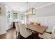 Elegant dining room featuring wainscoting, hardwood floors, and a modern light fixture at 95 Nesbit Reserve Ct, Alpharetta, GA 30022
