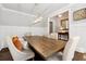 Spacious dining room with hardwood floors, wainscoting, and a stylish rectangular light at 95 Nesbit Reserve Ct, Alpharetta, GA 30022
