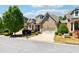 Charming brick home features a two-car garage, beautifully landscaped front yard, and dormer window at 95 Nesbit Reserve Ct, Alpharetta, GA 30022